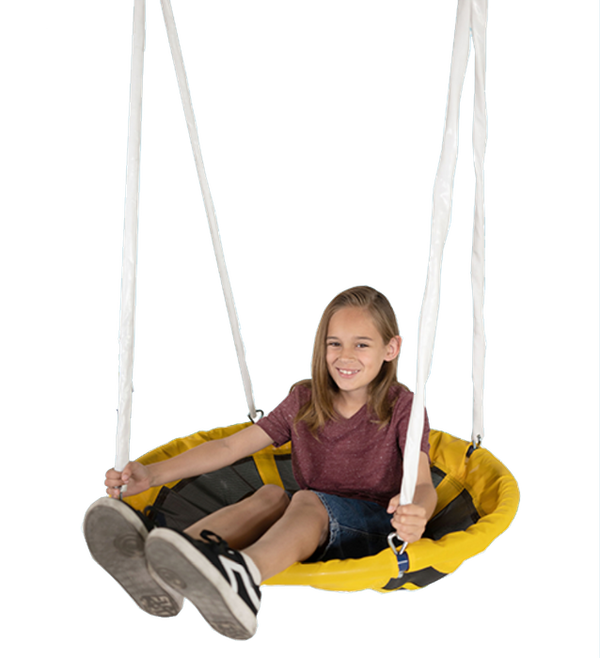 A smiling child riding a Sportspower saucer swing