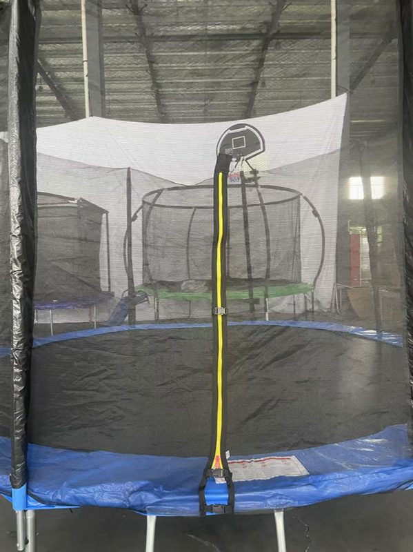 Inspecting a trampoline enclosure entrance for the ASTM-required warning label
